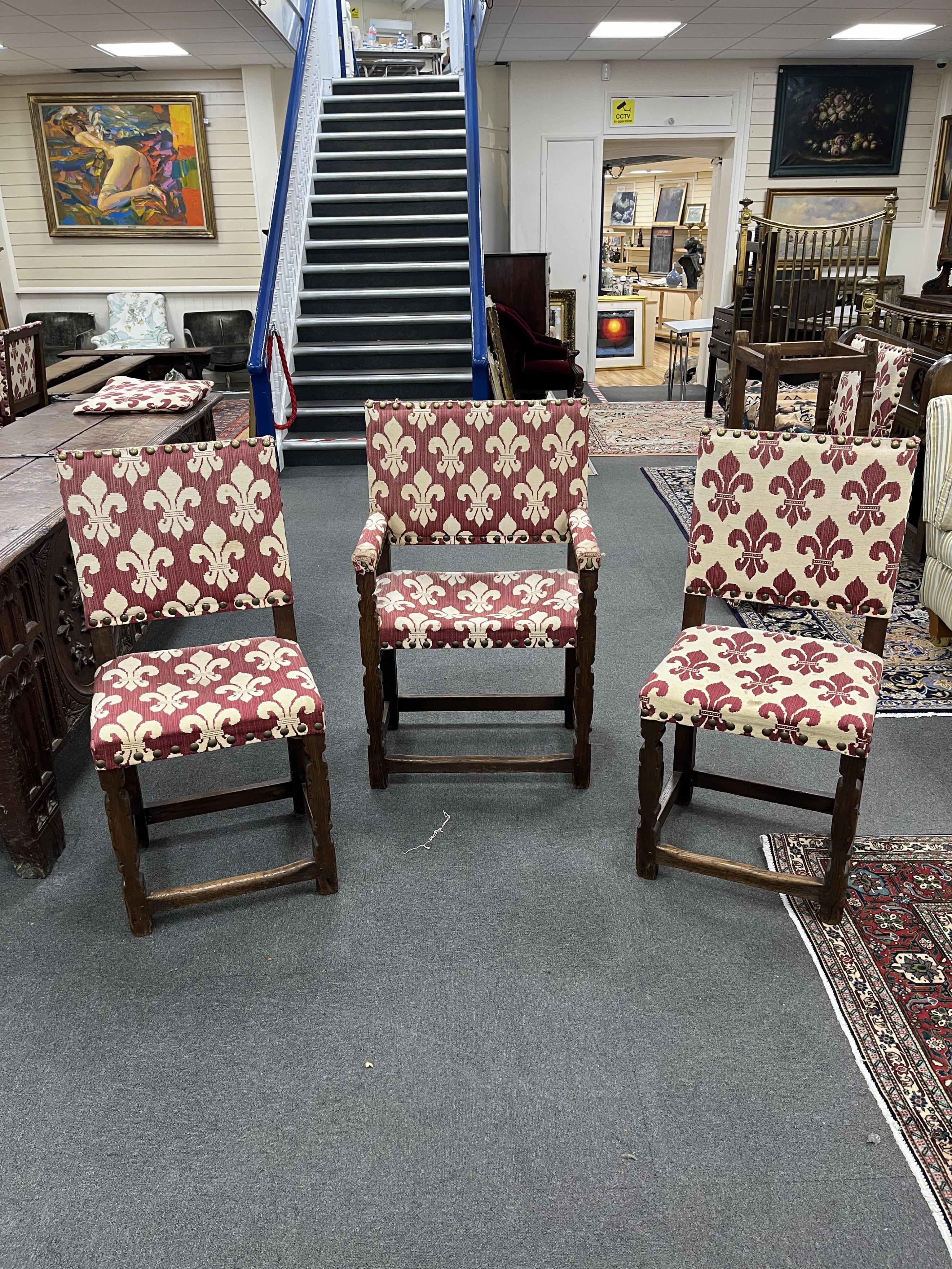 A set of sixteen upholstered oak dining chairs, in 17th century style, two with arms. Condition - fair , Provenance - made for Brede Place, Brede, Rye, East Sussex. Commissioned from Stuart interiors who have furnished s